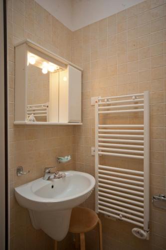 a bathroom with a sink and a mirror at Michelangelo Holiday & Family Resort in Lido di Spina