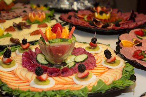 a table topped with a cake with fruit on it at Hotel Luxor in Playa de Palma