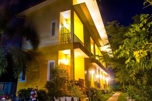 a yellow building with lights on the side of it at i-Style Lanta Boutique House --- SHA Extra Plus in Ko Lanta