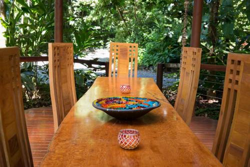 a wooden table with a bowl on top of it at Wildwood in Cape Tribulation
