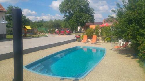 a swimming pool in a yard with a playground at Privat Bohemia in Šatov