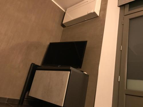 a television sitting on top of a wall at RM1H in Turin
