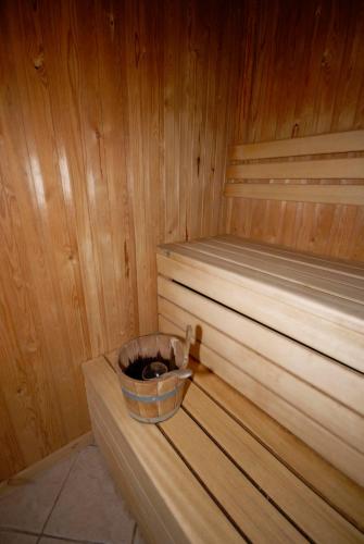 a wooden sauna with a bucket on top of it at Losehill House Hotel & Spa in Hope