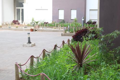 a fence in front of a courtyard with plants at Appartement ,Tram Parking and wifi gratui in Casablanca