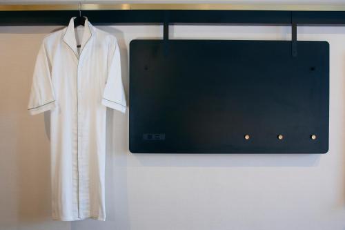 a white robe is hanging on a wall at Kyoto Tower Hotel Annex in Kyoto