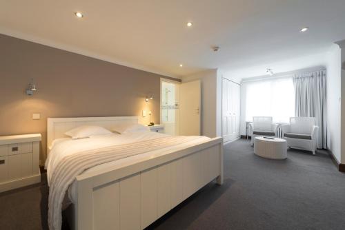 Postel nebo postele na pokoji v ubytování Hotel des Ardennes