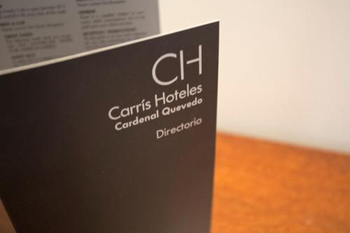 a black sign with white writing on it at Carris Cardenal Quevedo in Ourense