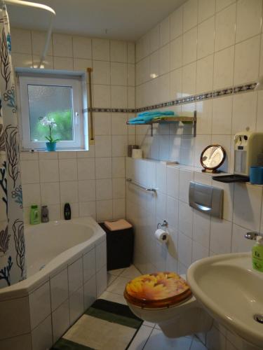 a bathroom with a tub and a sink at Apartment Gerda in Dieburg