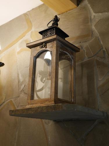 a lantern hanging on a stone wall at Biołe Izby in Chochołów