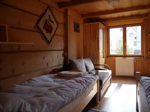 a bedroom with a bed in a wooden cabin at Biołe Izby in Chochołów