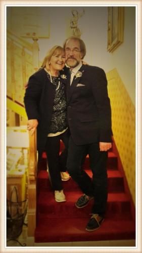 a man and a woman standing on stairs at Hotel Garni Concordia - Dolomites Home in Selva di Val Gardena