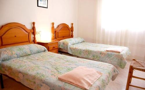 A bed or beds in a room at Casa Jasmin 1