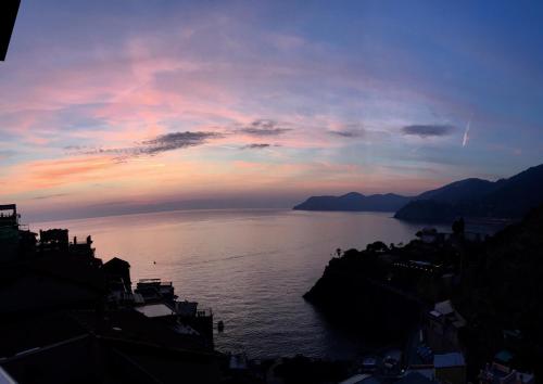 a view of a large body of water at sunset at Le Storie di Manarola in Manarola