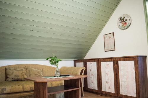 a living room with a couch and a table at Penzion u Lupíků in Frýdlant nad Ostravicí