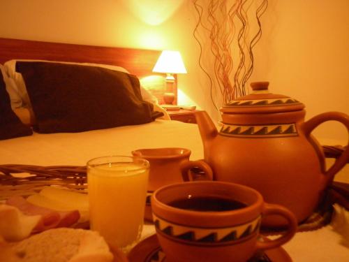 a table with a tray of food and a cup of orange juice at Cerro de la Cruz in Cafayate