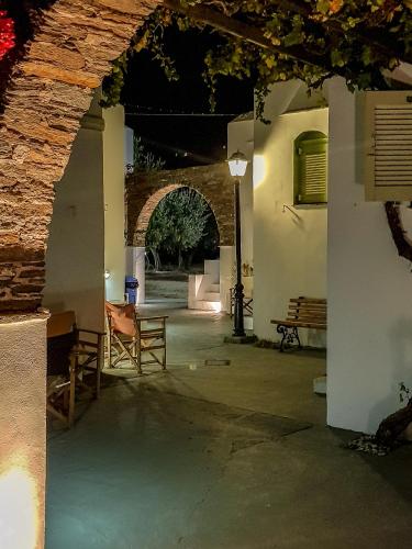 an entrance to a building with a table and benches at Giannakas Studios in Platis Yialos Sifnos