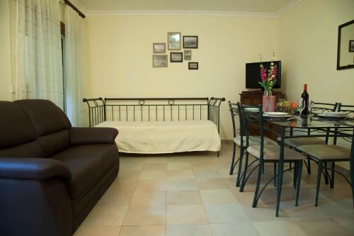 a living room with a couch and a table at Our Little House in Vila Real de Santo António