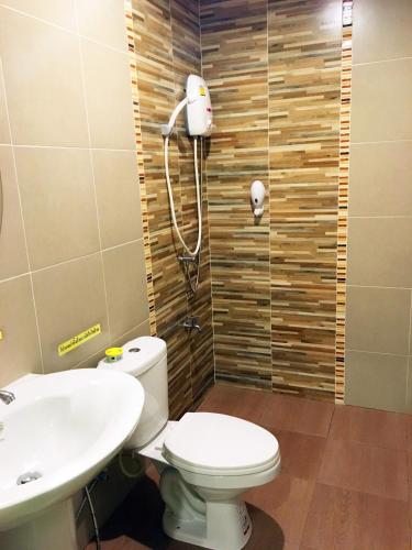 a bathroom with a toilet and a sink at Go Green Resort in Chumphon