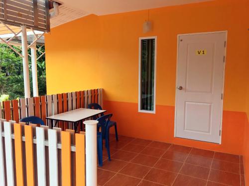 a room with a table and a white door at Go Green Resort in Chumphon