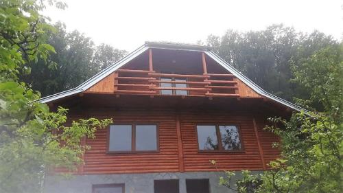 a log cabin with trees in the background at Etno domaćinstvo Milenković in Despotovac