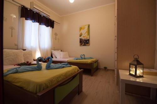 two beds in a room with two swans on them at Villa Amfimala in Georgioupolis