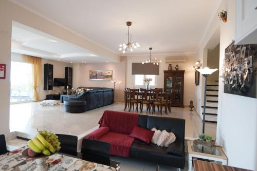 a living room with a couch and a table at Villa Amfimala in Georgioupolis