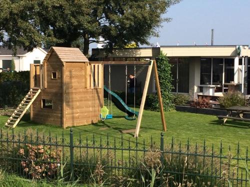 a play set in a yard with a playground at Vakantiepark Krabbenkreek in Sint Annaland