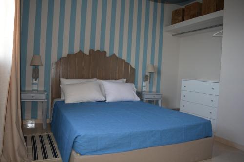 a bedroom with a blue bed with two night stands at Aqua Terra in Spárton
