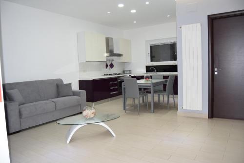 a living room with a couch and a table at VillAcri in Acri