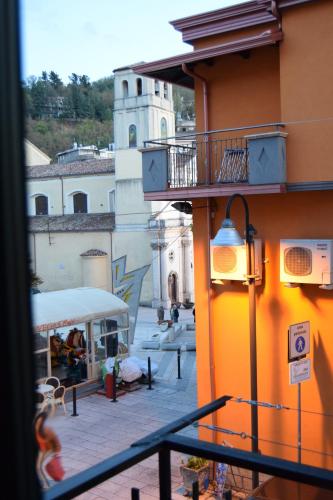 a view of a building with a balcony and a courtyard at VillAcri in Acri