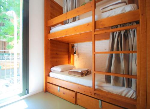 a bunk bed in a room with a window at Ten To Go Hostel in Barcelona