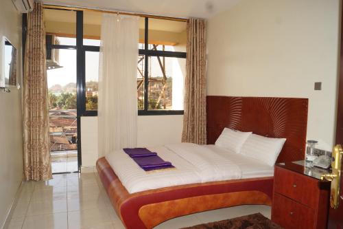 Postel nebo postele na pokoji v ubytování Hotel OK Kampala