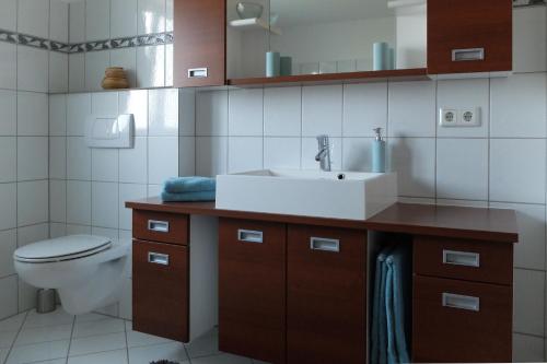 a bathroom with a sink and a toilet at Ferienwohnung Elsa in Höchst