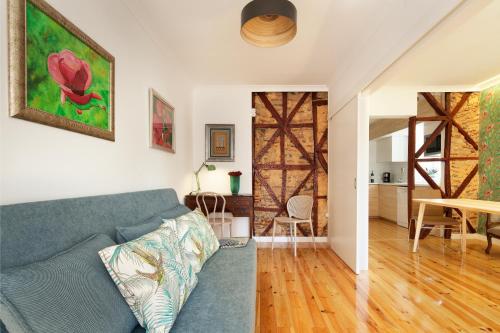 a living room with a blue couch and a table at FeelingLisbon Tejo in Lisbon
