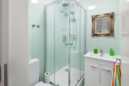 a bathroom with a shower and a toilet and a sink at FeelingLisbon Tejo in Lisbon