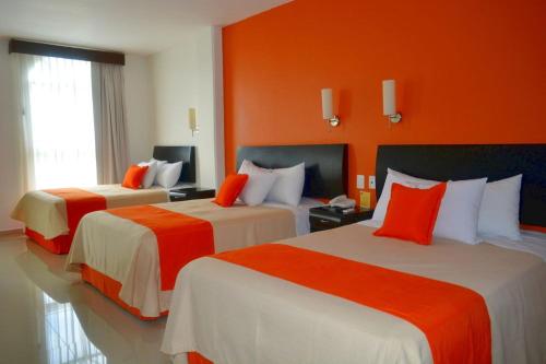 Cama o camas de una habitación en Hotel Baez Paraiso