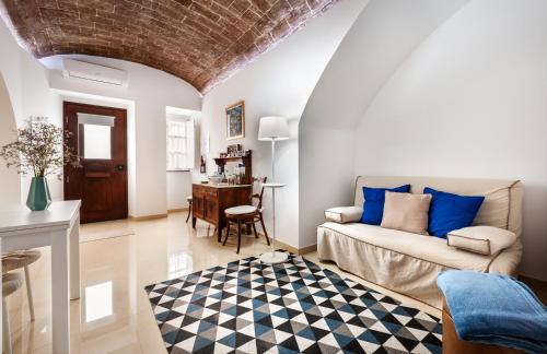 a living room with a couch and a table at Ebora Home - free garage - Centro Histórico in Évora