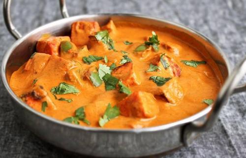 a metal pan filled with a bowl of curry at Kuber's Residency in Mahad