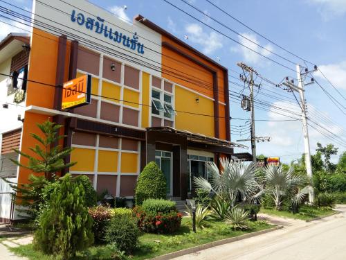 a building with a sign on the side of it at SB Mansion in Buriram