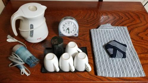 a table with a clock and some items on it at Ryokan Katsutaro in Tokyo