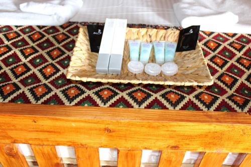 a table with a tray with three candles on it at Al Reem Desert Camp in Jalan Bani Buhassan