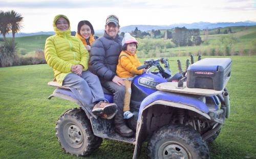 a family is sitting on a four wheeler vehicle at Tree House Lodge Bed & Breakfast in Cheviot