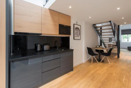 a kitchen with a counter top and a dining room at Aparthotel BC 29 Residence in Kraków