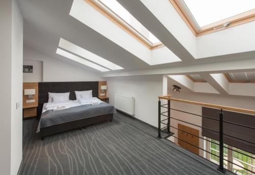 a bedroom with a bed and a skylight at Aparthotel BC 29 Residence in Kraków
