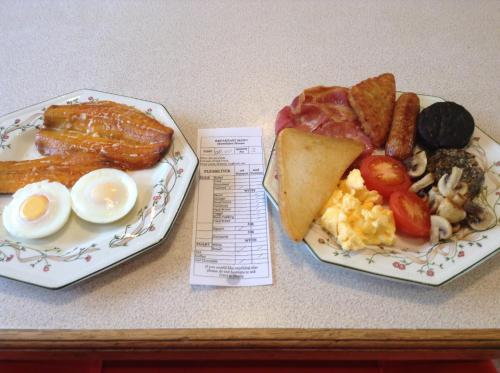 two plates of breakfast food on a table at Hundalee House in Jedburgh