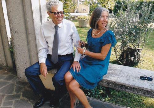 a man and a woman sitting on a bench at antica casa "le rondini" in Borgo a Buggiano