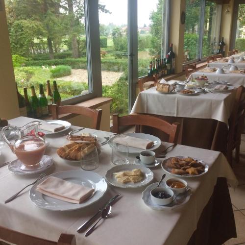 a long table with plates of food on it at Hostaria Da Ivan in Roccabianca