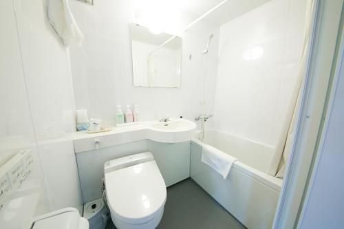 a white bathroom with a toilet and a sink at Yamagata-City AKOYA in Yamagata