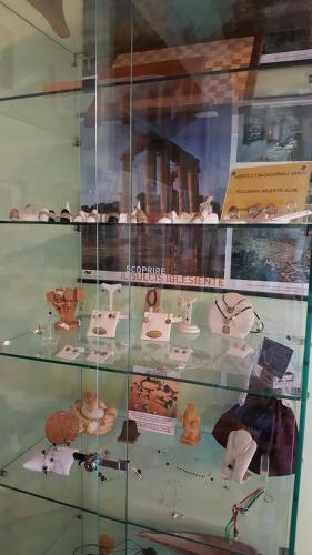 a glass display case with many different types of pastries at B&B Nuraximannu in Santadi