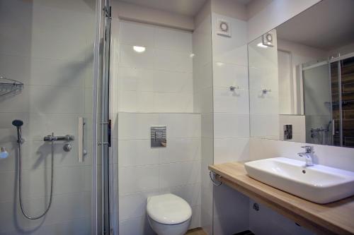 a bathroom with a toilet and a sink and a shower at Vip Casa Club Zlatibor in Zlatibor